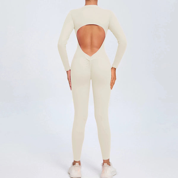 Beige backless long sleeve sports jumpsuit with front zipper designed for extreme comfort and confidence in the gym by allowing you to show off that pumped back