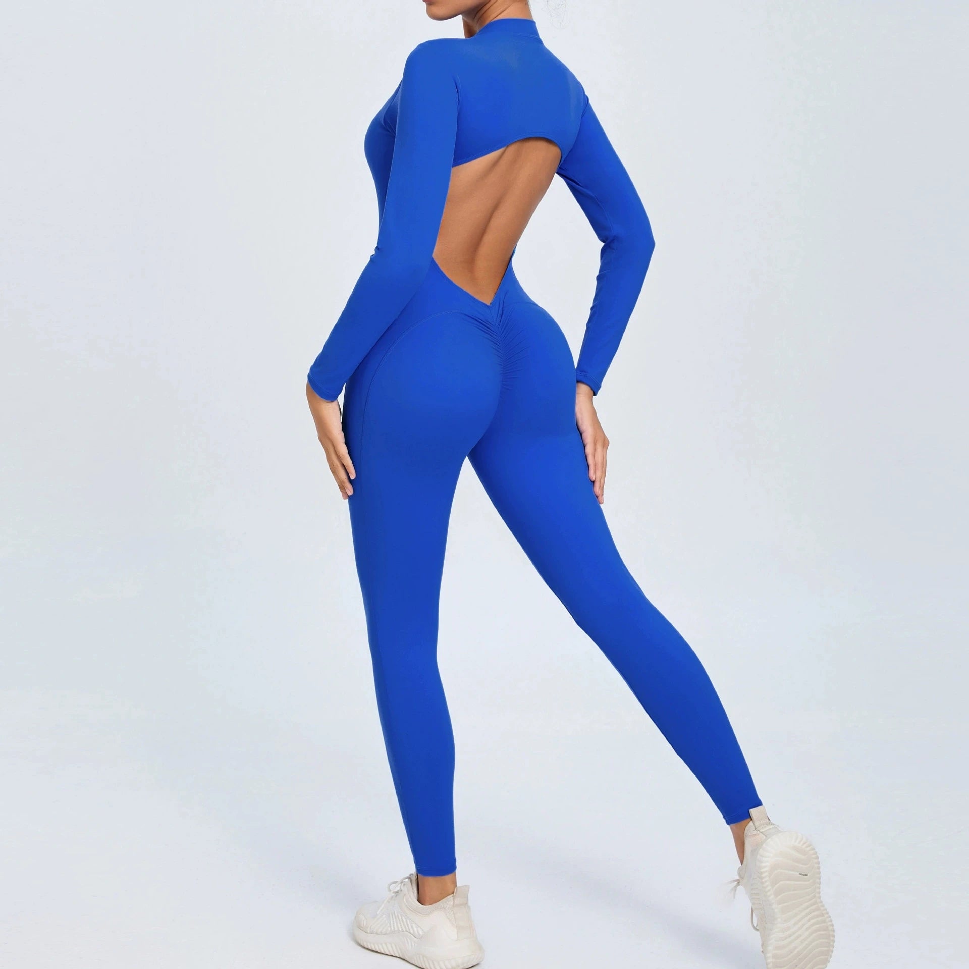 Blue backless long sleeve sports jumpsuit with front zipper designed for extreme comfort and confidence in the gym by allowing you to show off that pumped back