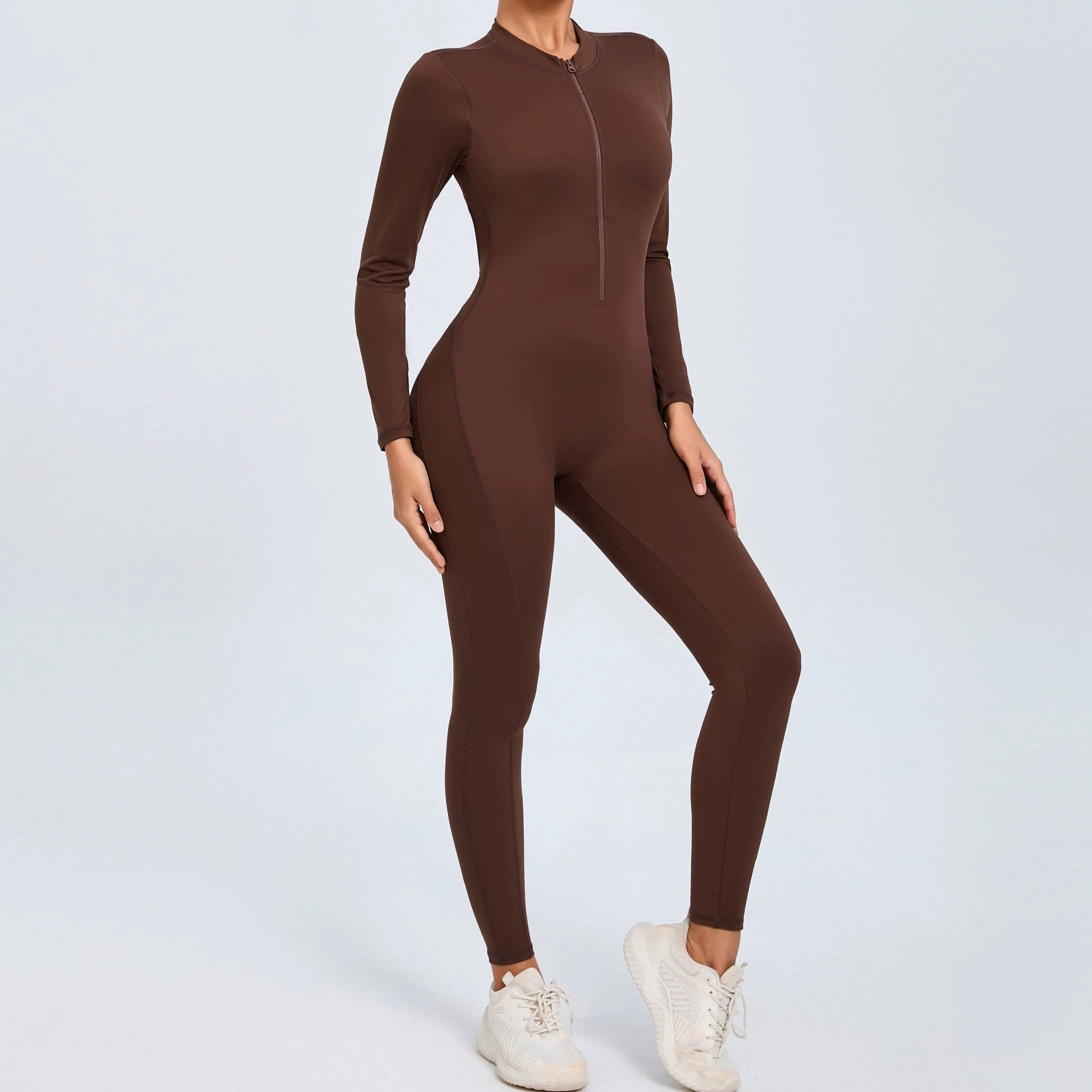 Brown backless long sleeve sports jumpsuit with front zipper designed for extreme comfort and confidence in the gym by allowing you to show off that pumped back