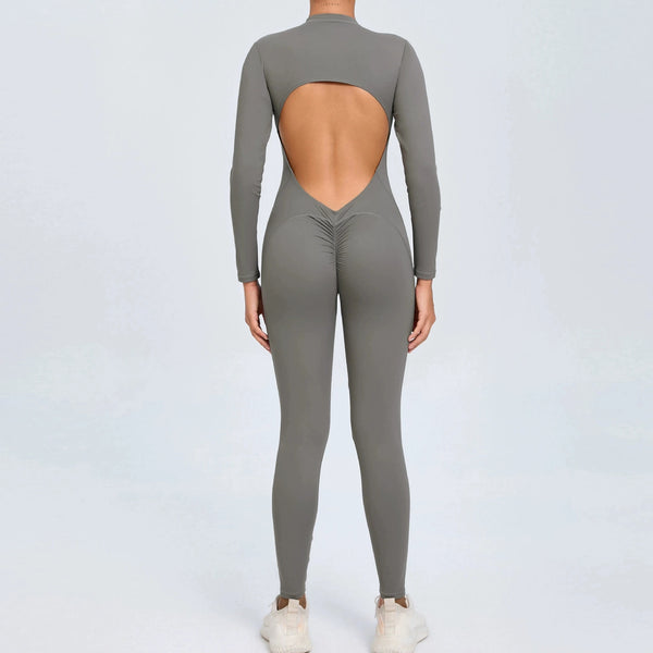 Grey backless long sleeve sports jumpsuit with front zipper designed for extreme comfort and confidence in the gym by allowing you to show off that pumped back