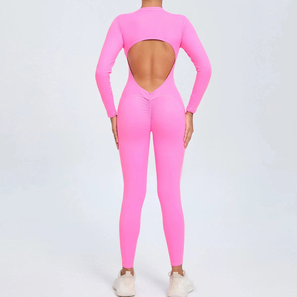 Pink backless long sleeve sports jumpsuit with front zipper designed for extreme comfort and confidence in the gym by allowing you to show off that pumped back
