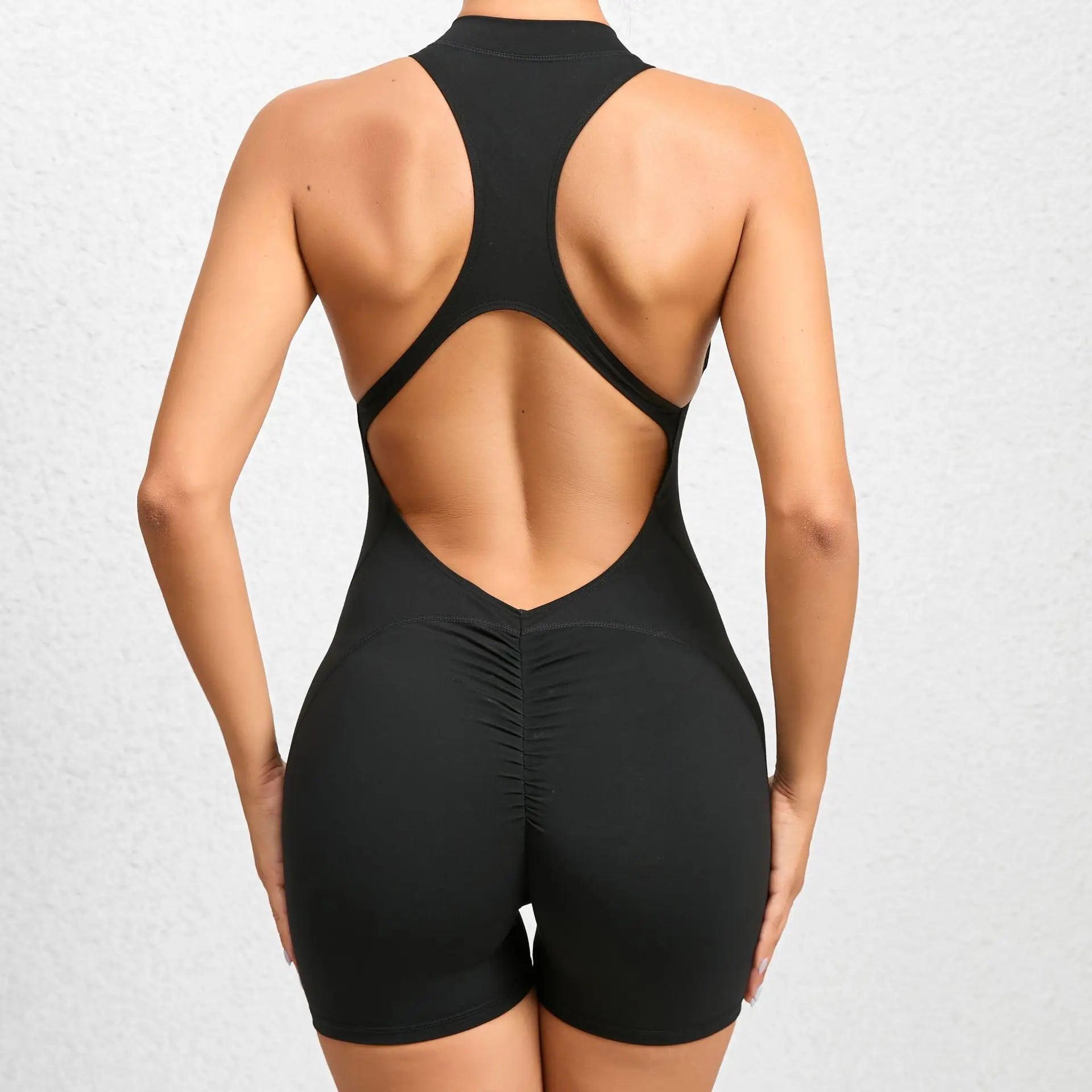 black backless sleeveless sports short jumpsuit with front zipper designed for extreme comfort and confidence in the gym allowing for huge freedom of movement during training