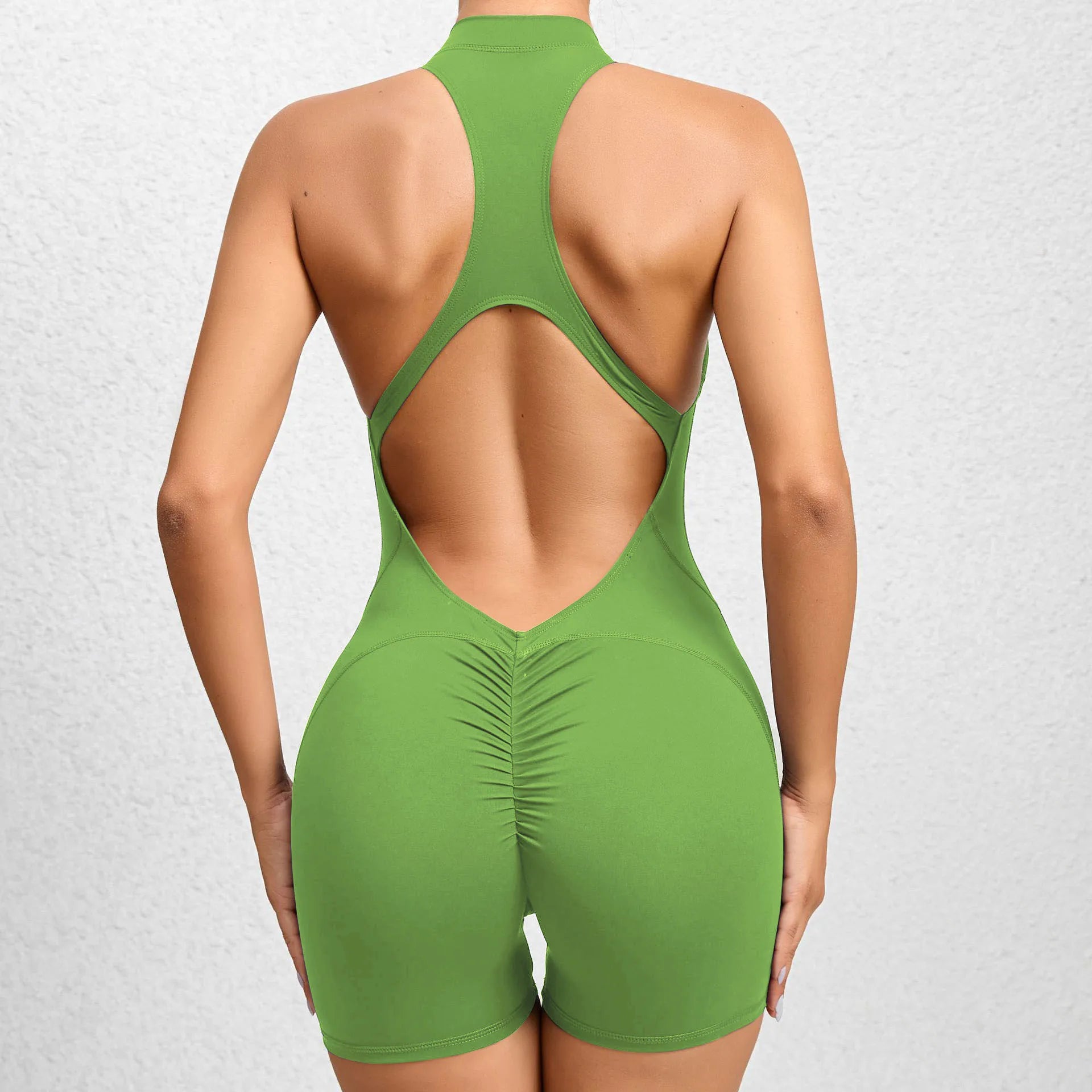 green backless sleeveless sports short jumpsuit with front zipper designed for extreme comfort and confidence in the gym allowing for huge freedom of movement during training