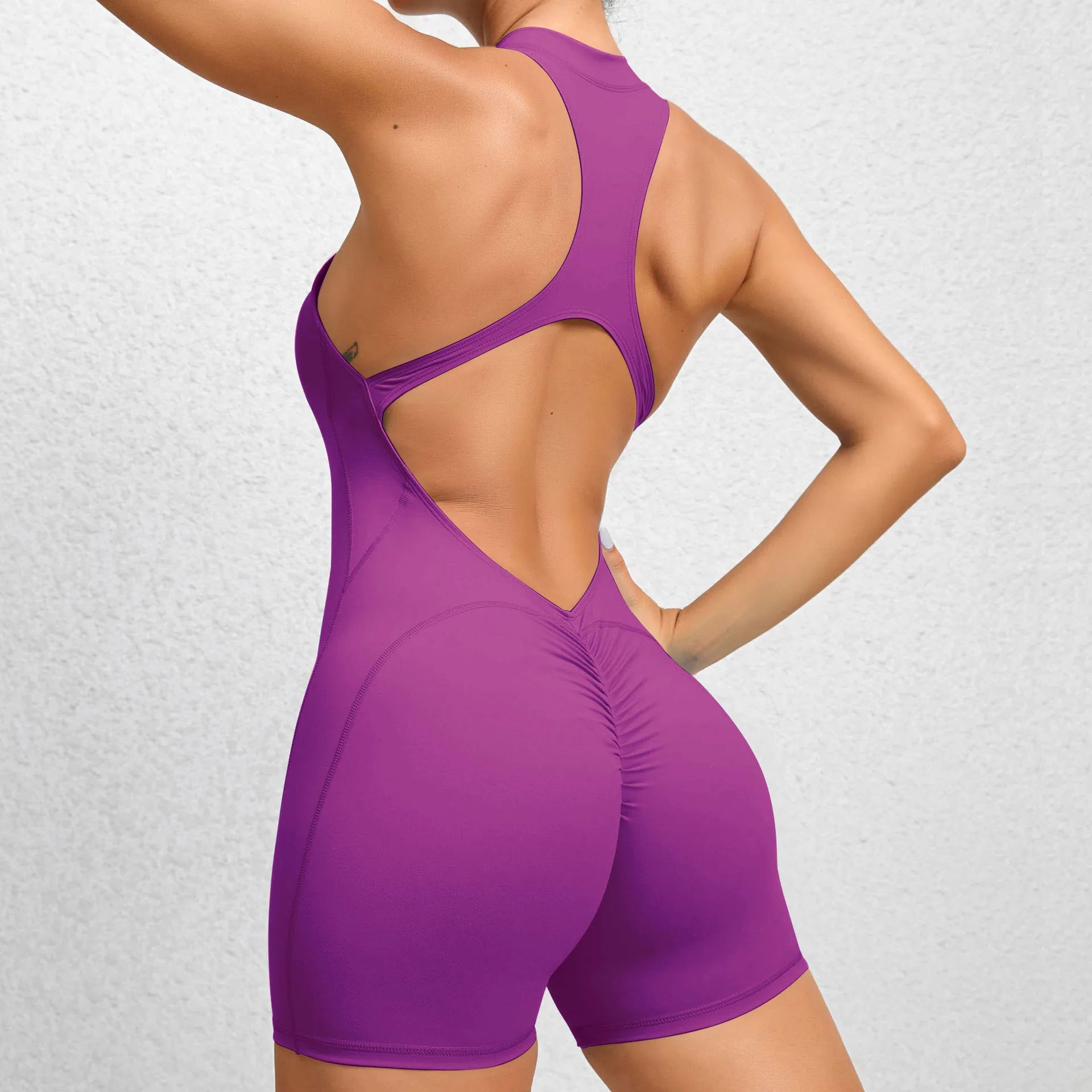 Purple backless sleeveless sports short jumpsuit with front zipper designed for extreme comfort and confidence in the gym allowing for huge freedom of movement during training
