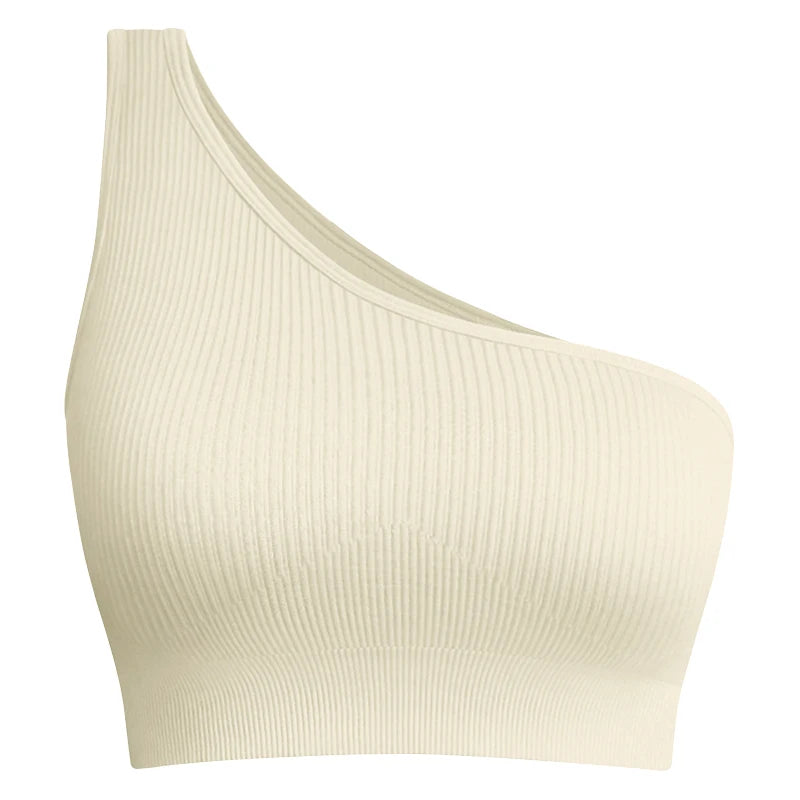 Beige ribbed sports bra with a single shoulder strap designed for freedom during intense gym and training sessions